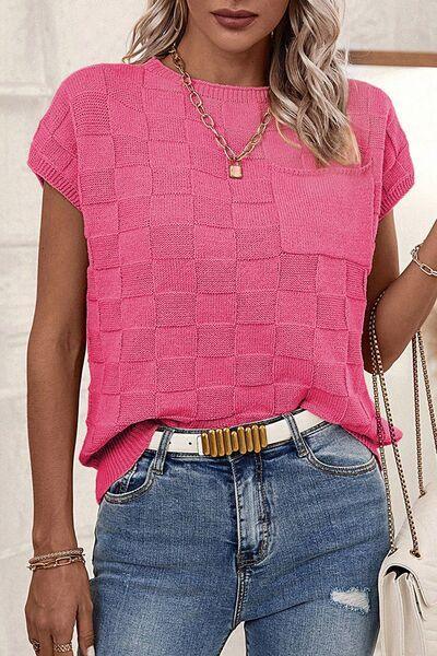 a woman wearing a pink sweater and jeans