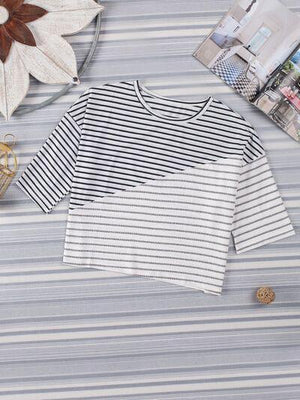 a white and black striped shirt sitting on top of a table