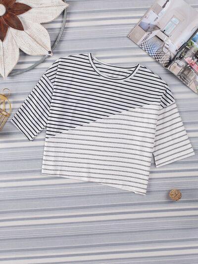 a white and black striped shirt sitting on top of a table