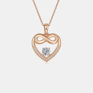 a heart shaped pendant with a diamond in the center