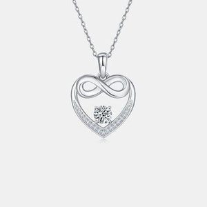 a heart shaped pendant with a diamond in the center