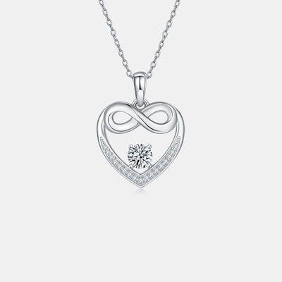 a heart shaped pendant with a diamond in the center