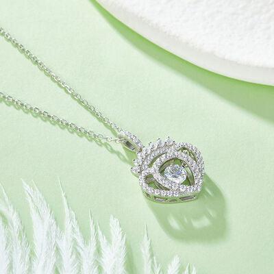 a necklace with a heart shaped diamond on it