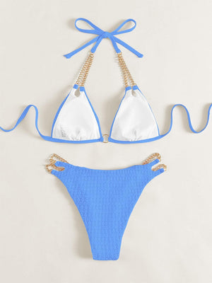 a blue and white bikini with a gold chain