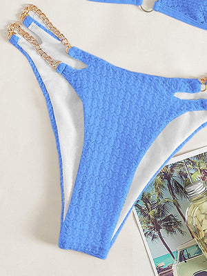 a blue and white bathing suit and a magazine