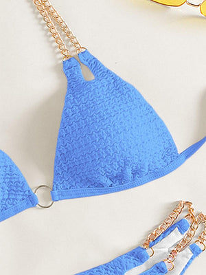 a pair of blue bikinisuits with chains on them