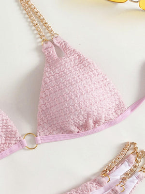 a pair of pink bikinisuits with chains attached to them
