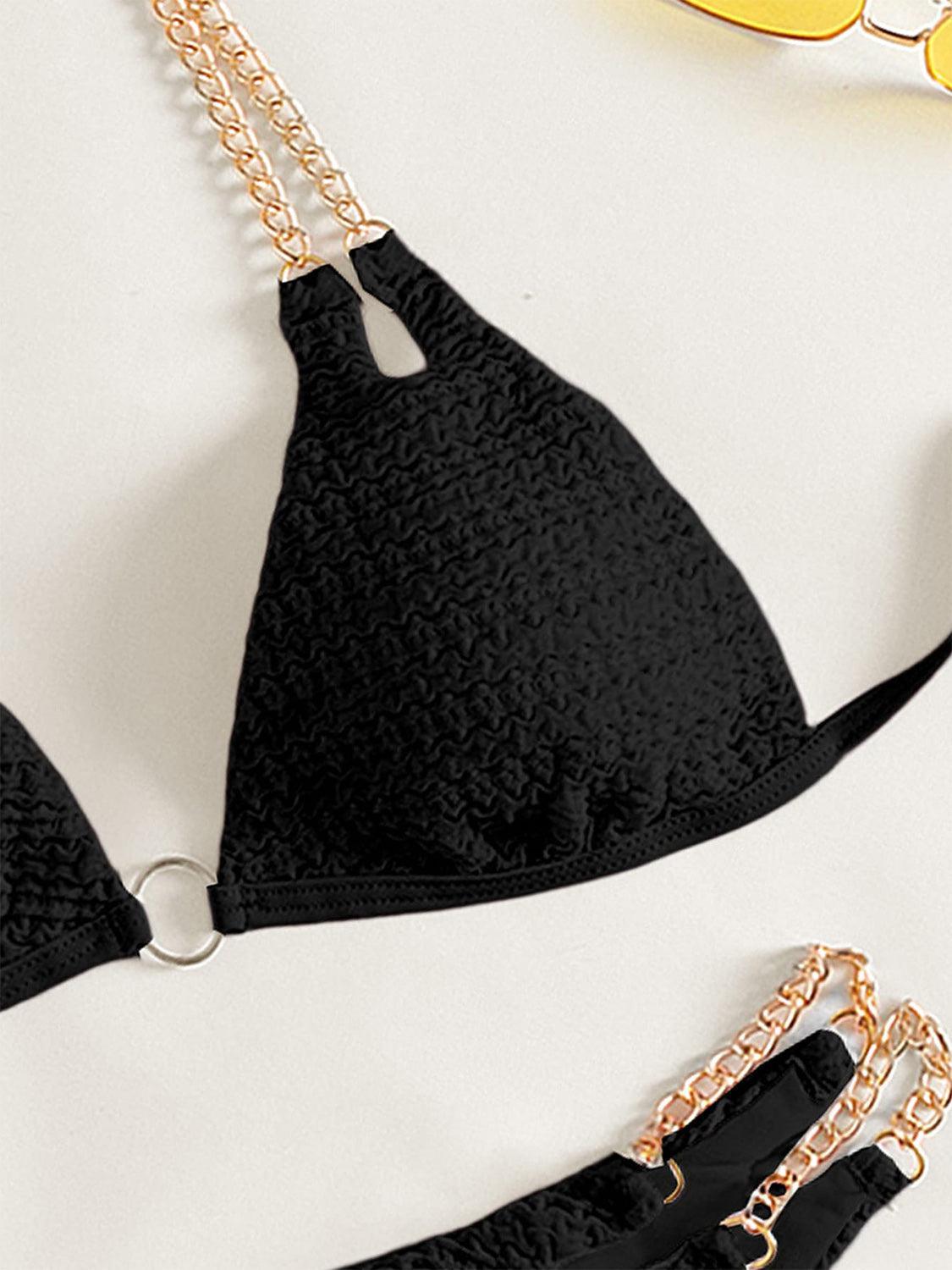 a pair of black bras with chains attached to them