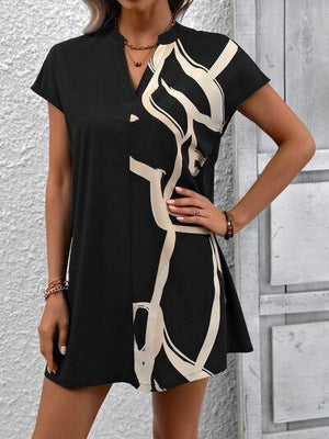 a woman posing for a picture in a black and white dress