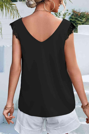 a woman wearing a black top and white shorts