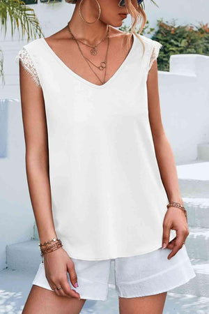 a woman wearing a white top and white shorts