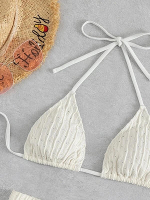 a white bikini top with a straw hat on top of it