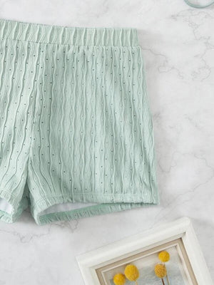 a pair of mint green shorts next to a framed photograph