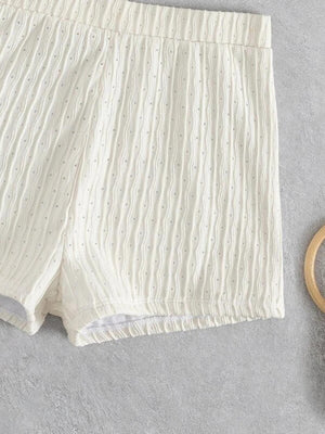 a pair of shorts next to a pair of scissors