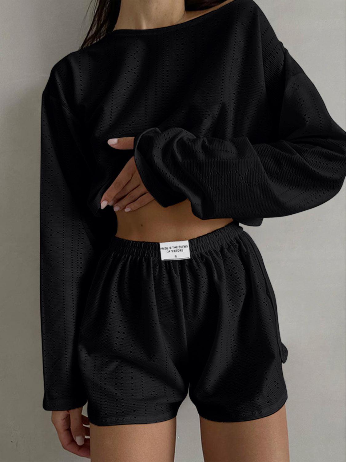 a woman wearing a black top and shorts