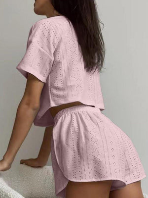 a woman in a pink top and shorts