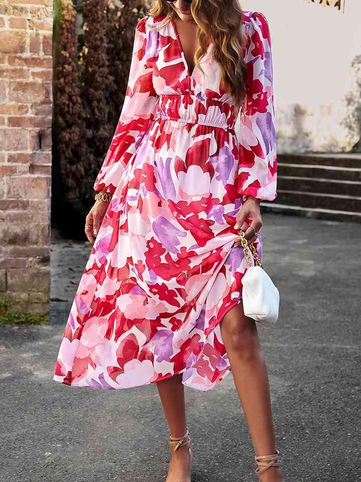 a woman in a red floral print dress