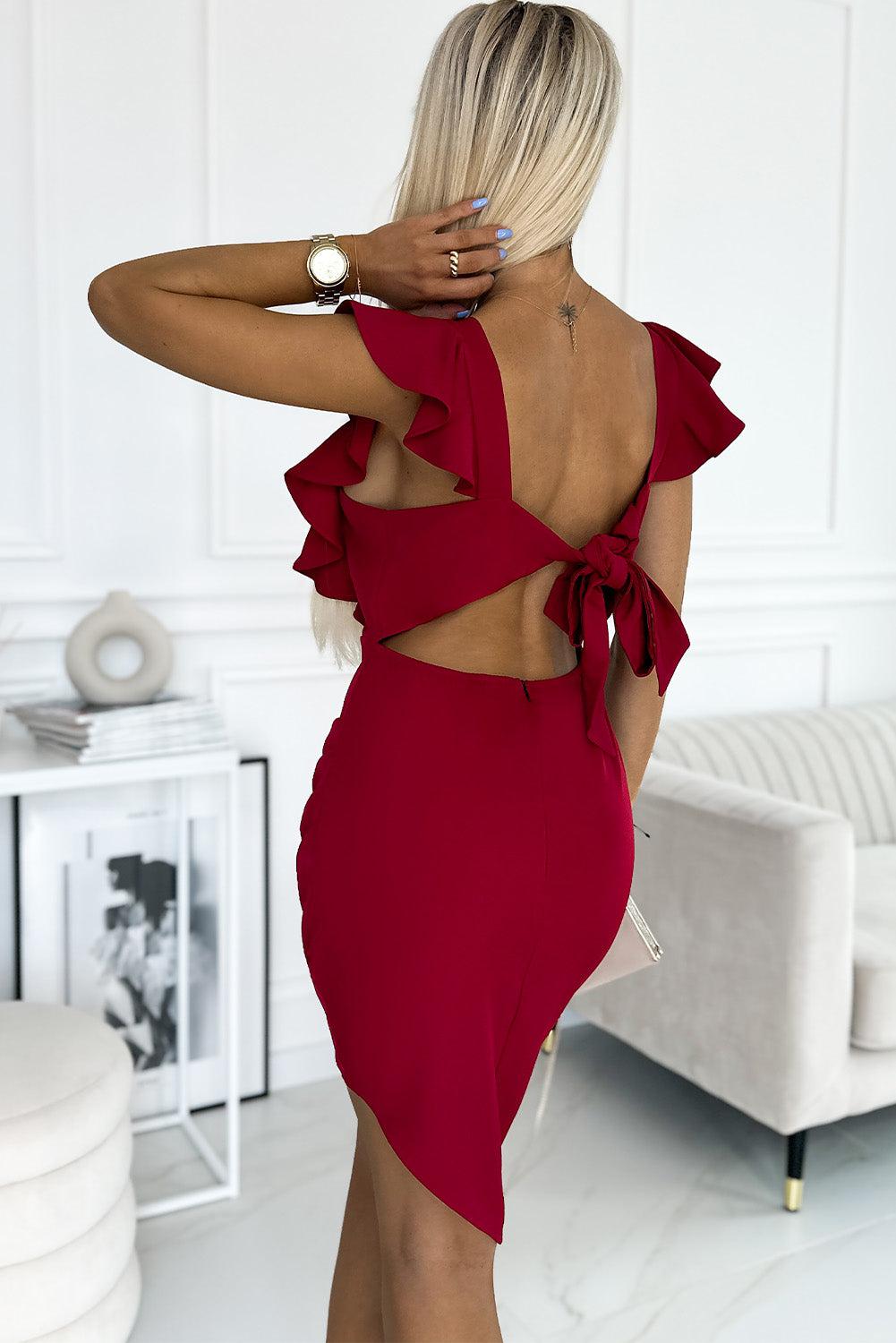 a woman wearing a red dress with a cut out back