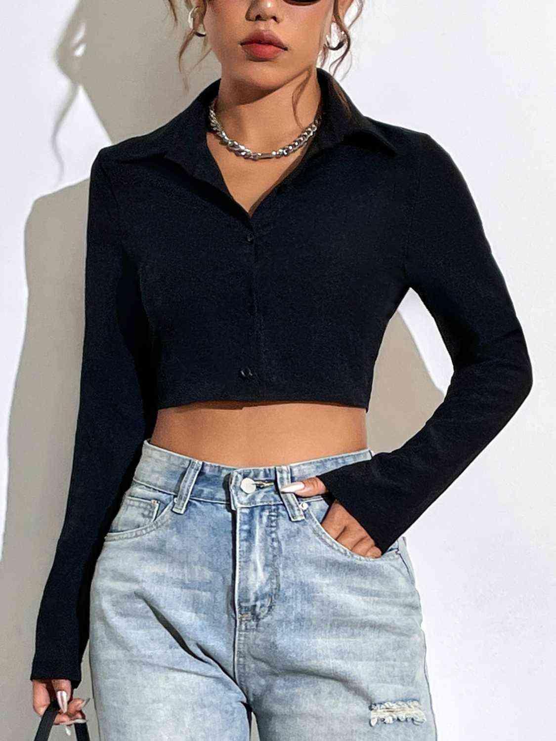 a woman wearing a black crop top and jeans