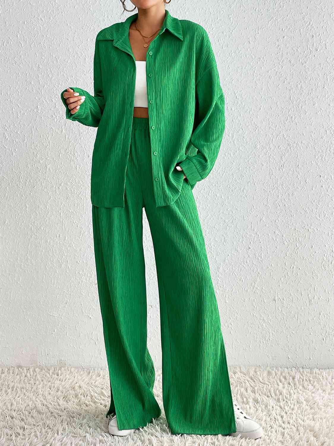 a woman in a green jacket and wide legged pants