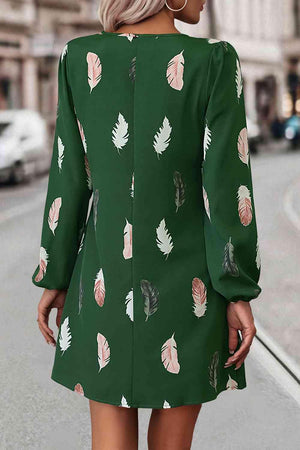 a woman wearing a green dress with leaves on it