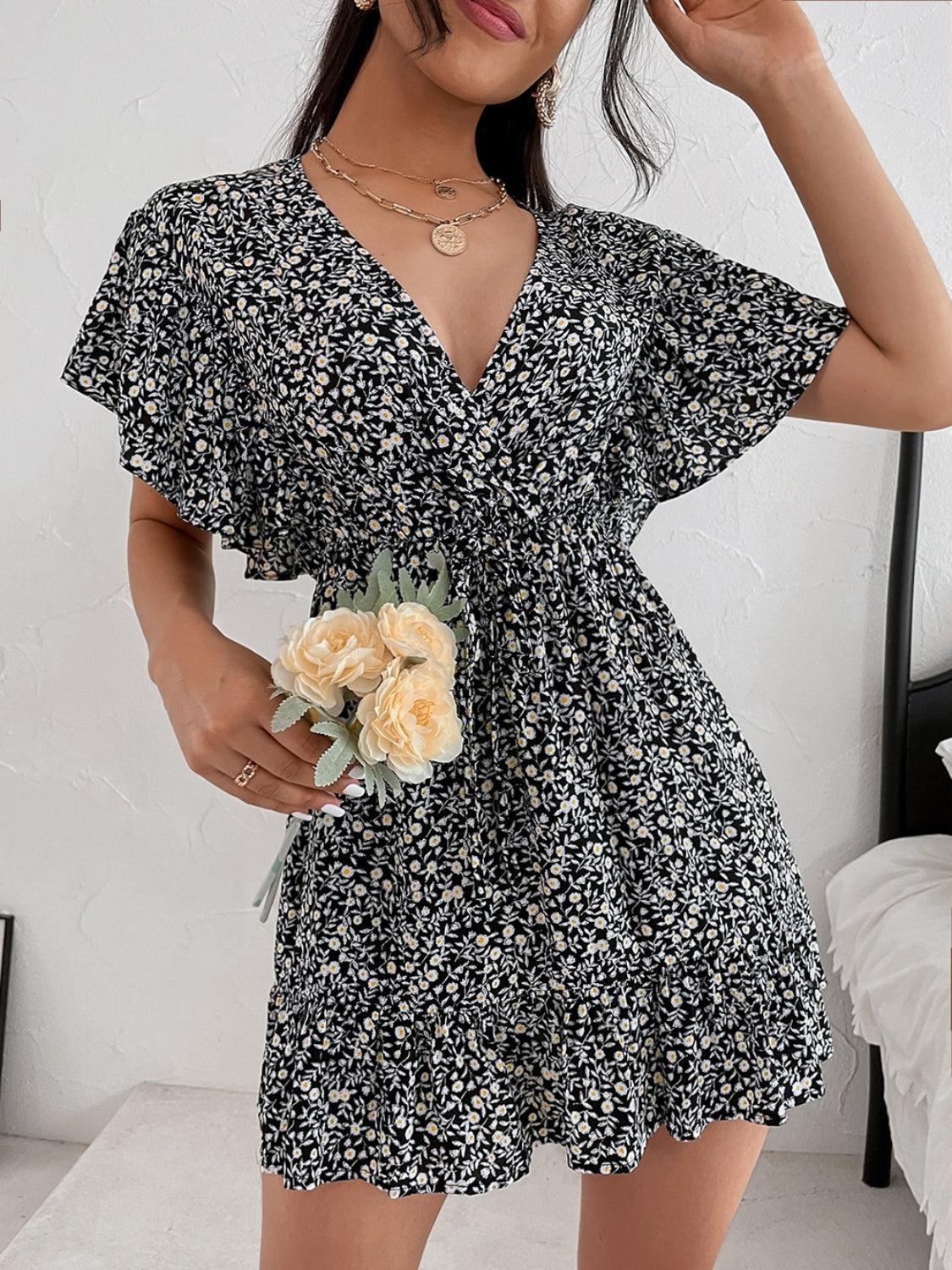 a woman in a black and white dress holding a flower