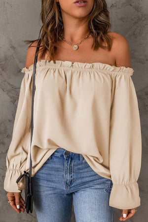 a woman wearing a off the shoulder top