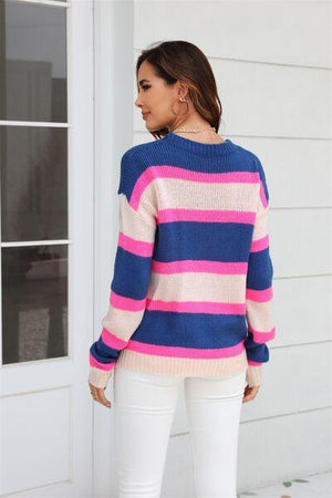a woman wearing a pink and blue striped sweater