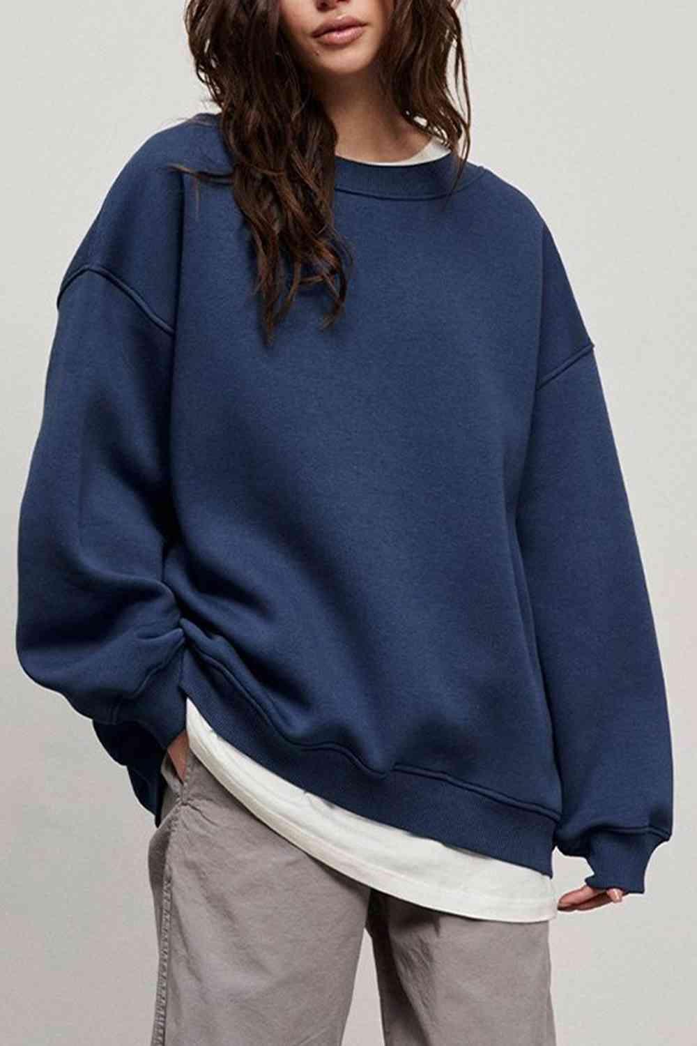 a woman wearing a blue sweatshirt and khaki pants