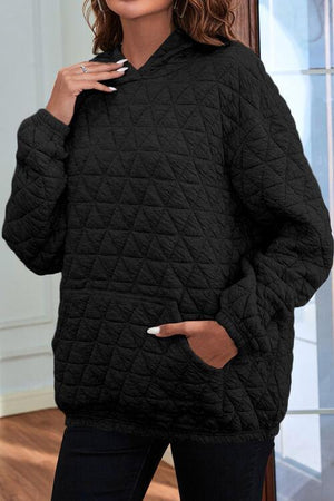 a woman wearing a black quilted jacket