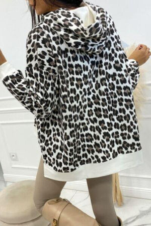 a woman wearing a leopard print jacket and leggings