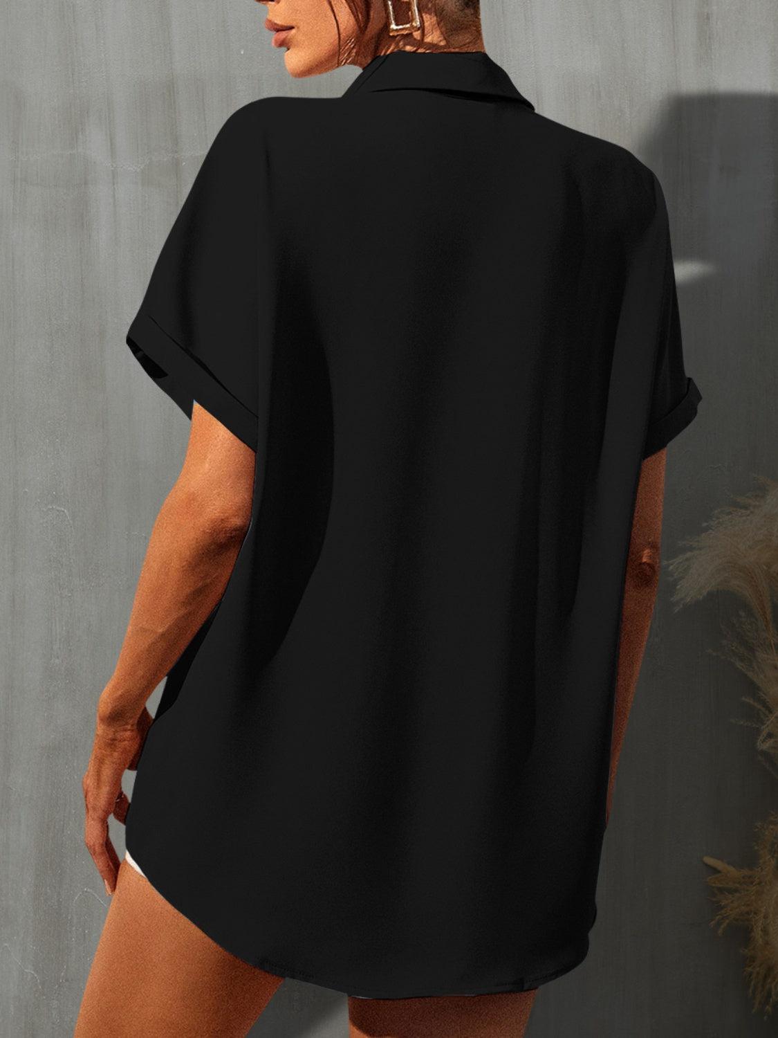 a woman wearing a black shirt and shorts