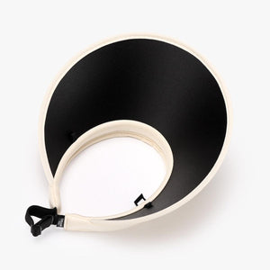 a black and white bowl on a white surface