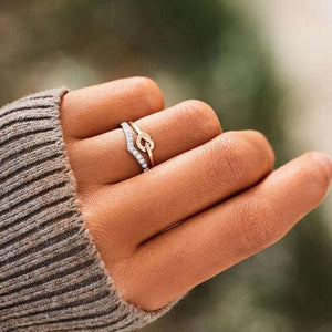 a woman's hand with a ring on it