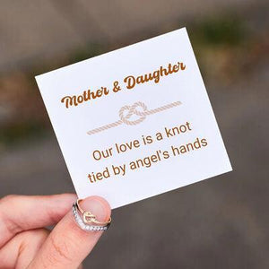 a person holding a card with a knot on it