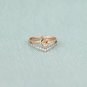 a gold ring with a heart on top of it