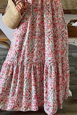 a woman in a floral dress holding a straw bag