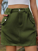 a close up of a person wearing a green skirt