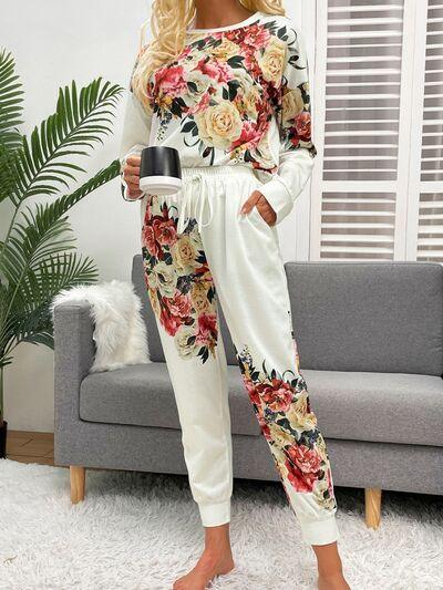 a woman standing in a living room holding a cup