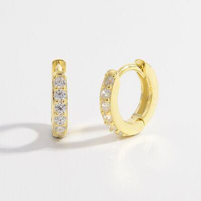a pair of gold hoop earrings with diamonds