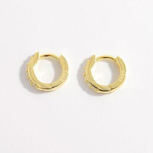 a pair of gold hoop earrings on a white background