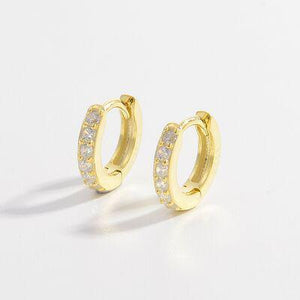 a pair of gold hoop earrings with diamonds