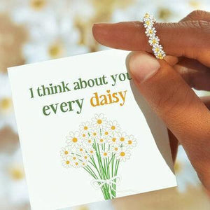 a person holding a card with a flower on it