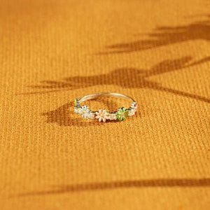 a close up of a ring with flowers on it