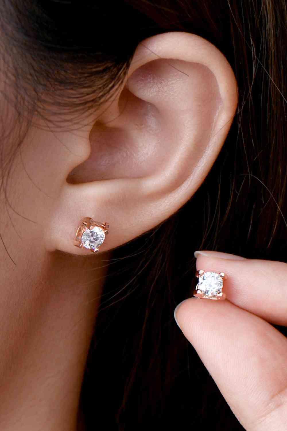 a close up of a person wearing a pair of earrings