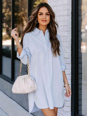 a woman wearing a light blue shirt dress