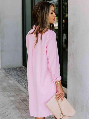 a woman wearing a pink shirt dress and heels