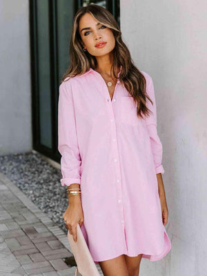 a woman wearing a pink shirt dress