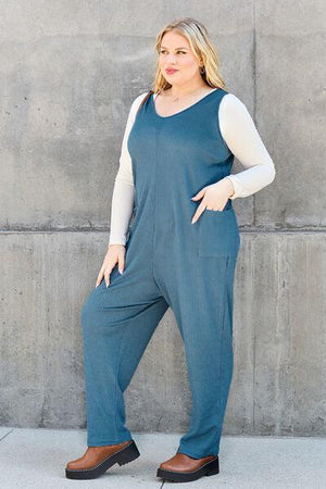 a woman standing in front of a concrete wall