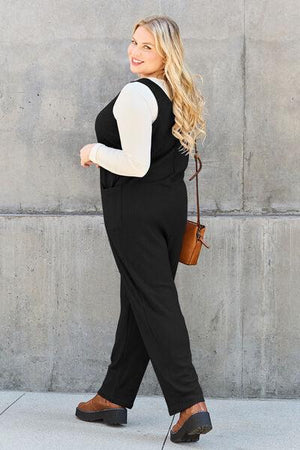a woman in black and white is walking down the street